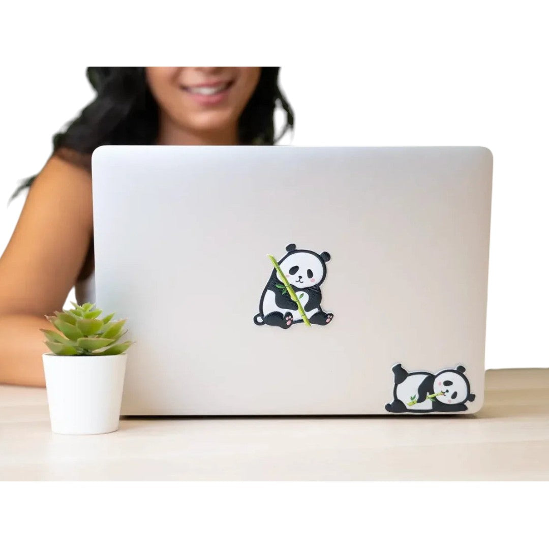 Quiscuola.it – Zaini, Astucci e Diari Scuola 3D panda stickers applied to a laptop lid with a person in the background
